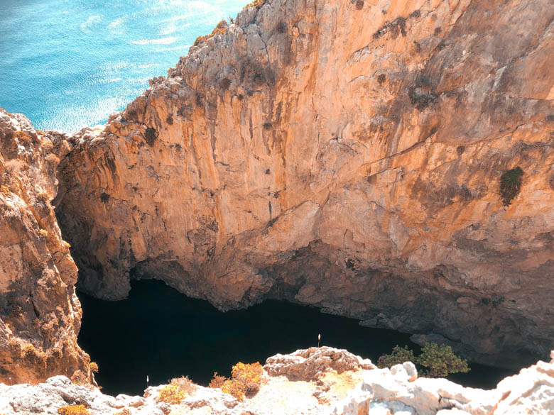 a hidden, secret saltwater lake in the middle of the cliffs next to agiofaraggo beach in southern crete