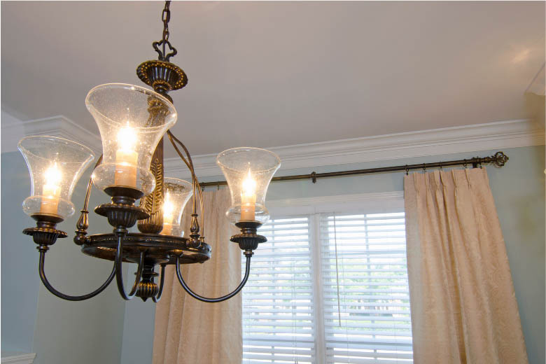 a four light bulb chandelier that is a typical light fixture in german apartments