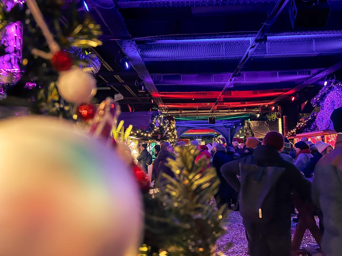 christmas decorations frame the lgbt queer xmas market under nollendorfplatz train station in berlin