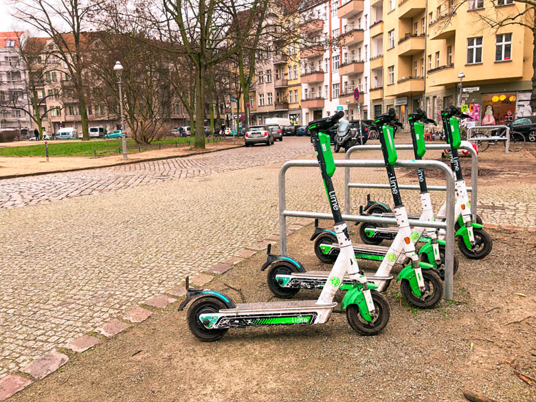 a row of lime electric scooters in berlin