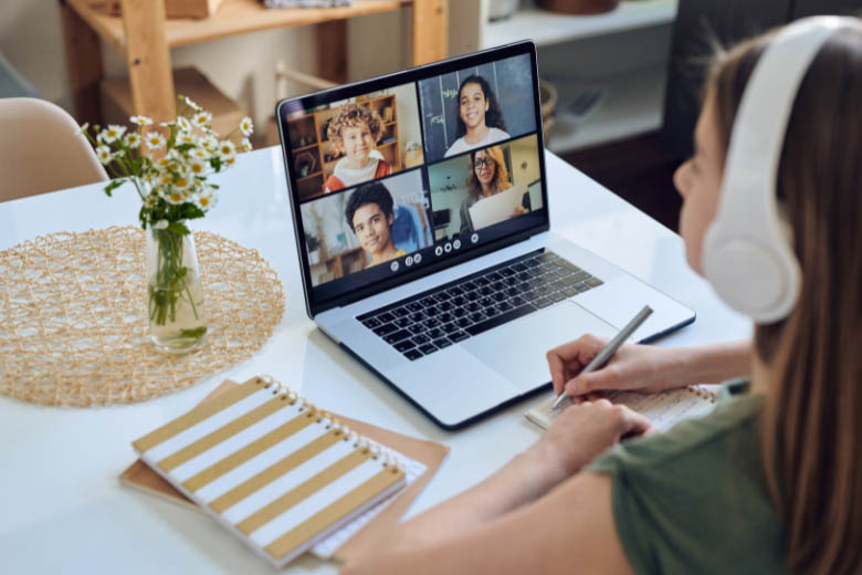 a girl wearing earphones taking online language classes on zoom