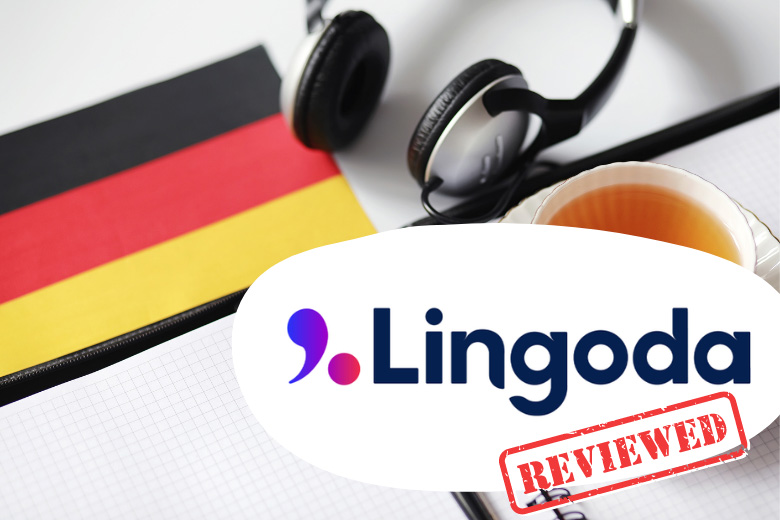 a german flag lies next to a pair of earphones, notebook and a cup of tea with the text overlay Lingoda review