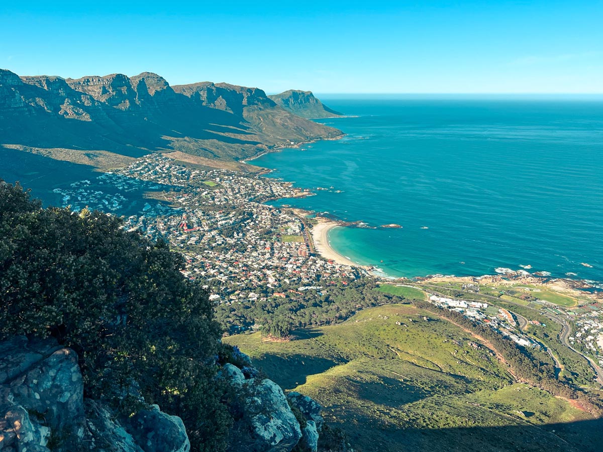 views from the top of lion's head hiking trail looking down on camps bay beach