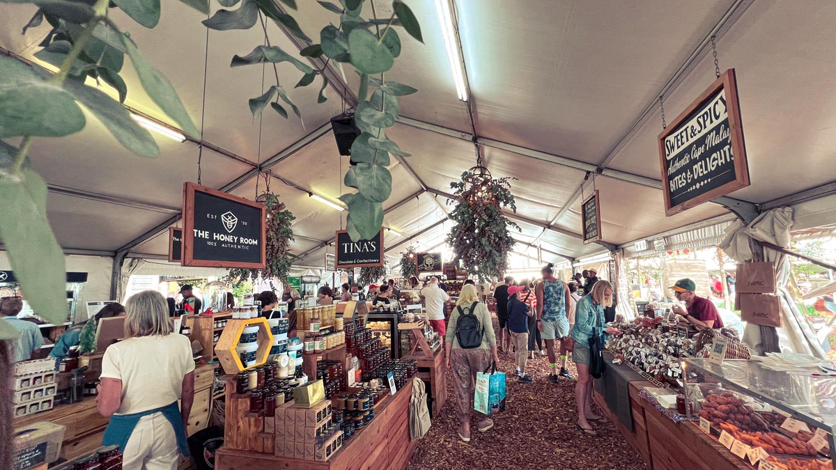 the indoor oranjezicht city farm market bustling with locals and tourists 