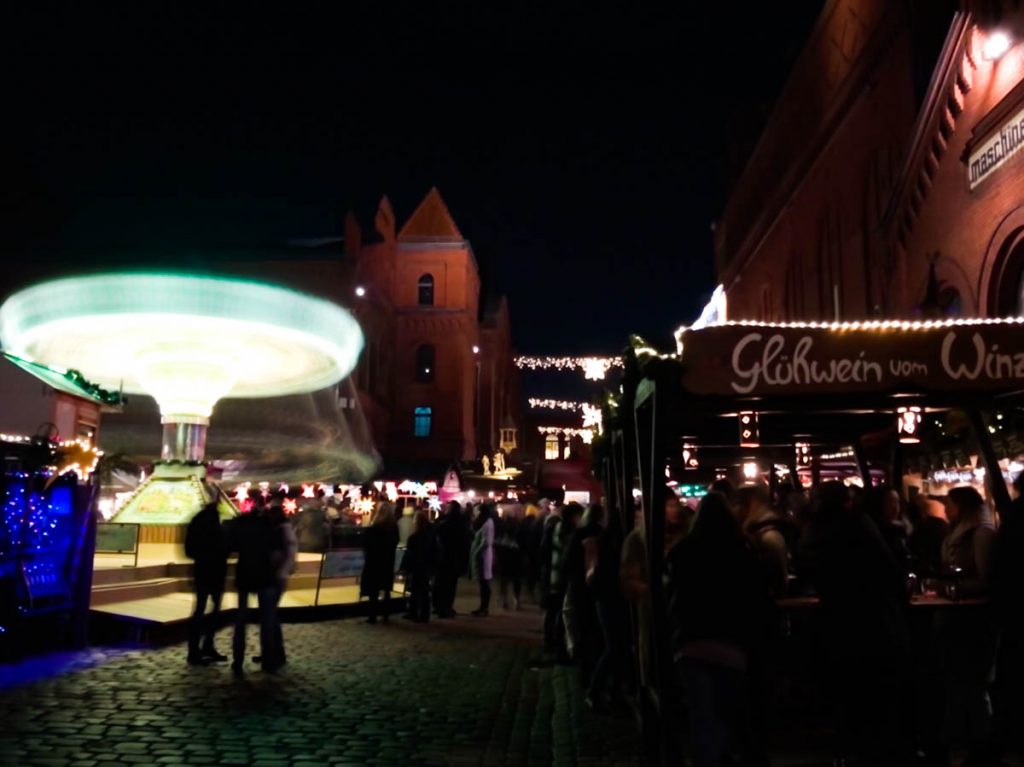 german christmas market in berlin kulturbrauerei with colourful and bright carousel