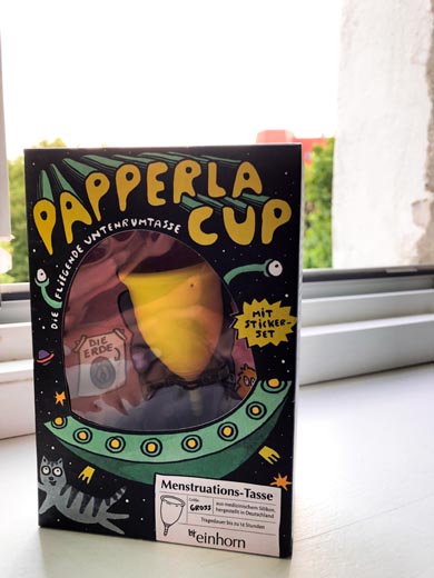 a yellow menstrual cup by papperlacup in a box 