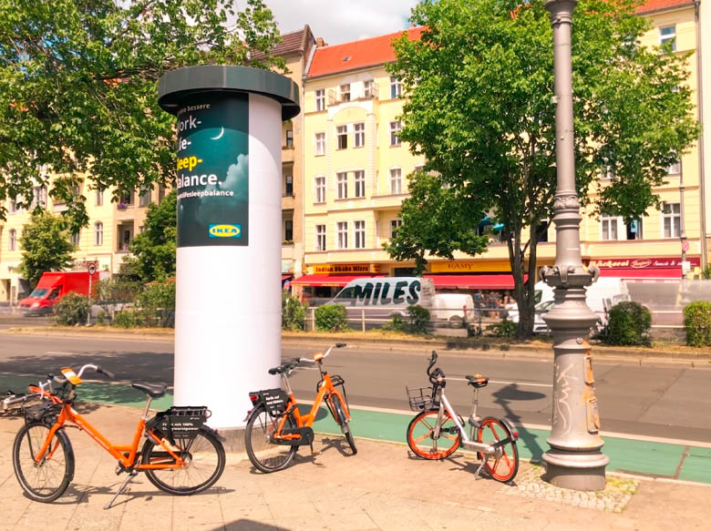 donkey republic and mobikes parked along the main road hermannstrasse in berlin