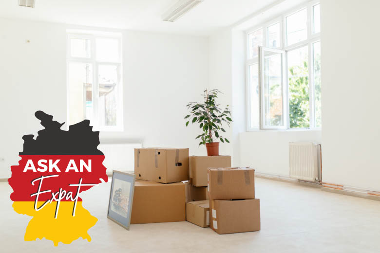 a stack of moving boxes standing in the middle of an apartment in Germany 