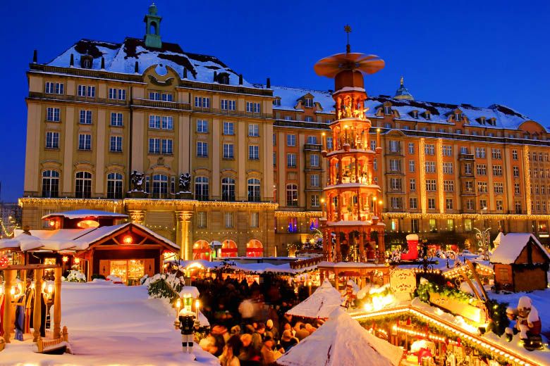 famous striezelmarkt christmas market in dresden with snow covering the roof and ground at night 