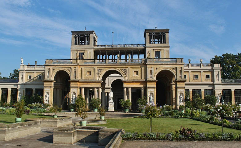 orangery palace in sanssouci park, potsdam germany with its italian renaissance inspired architecture and statue of king frederick william iv in front