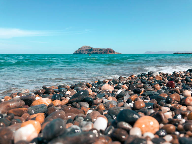 a colorful pebble stone beach on crete island in greece called platanias beach 