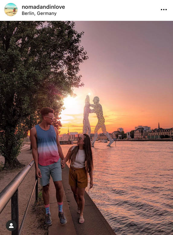 best sunset photo spot in berlin along the spree river in berlin in front of the molecule man sculpture
