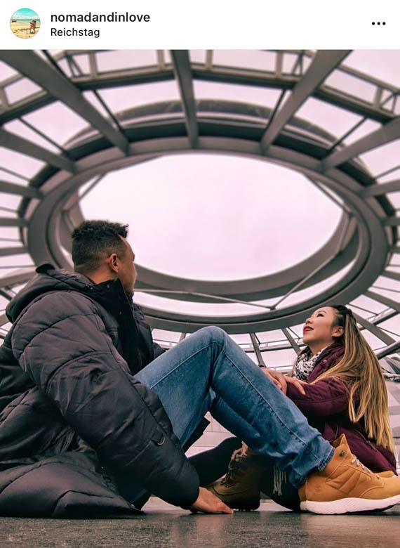 a couple sitting on the ground looking up at the berlin reichstag dome is one of the best secret photo spots in mitte 