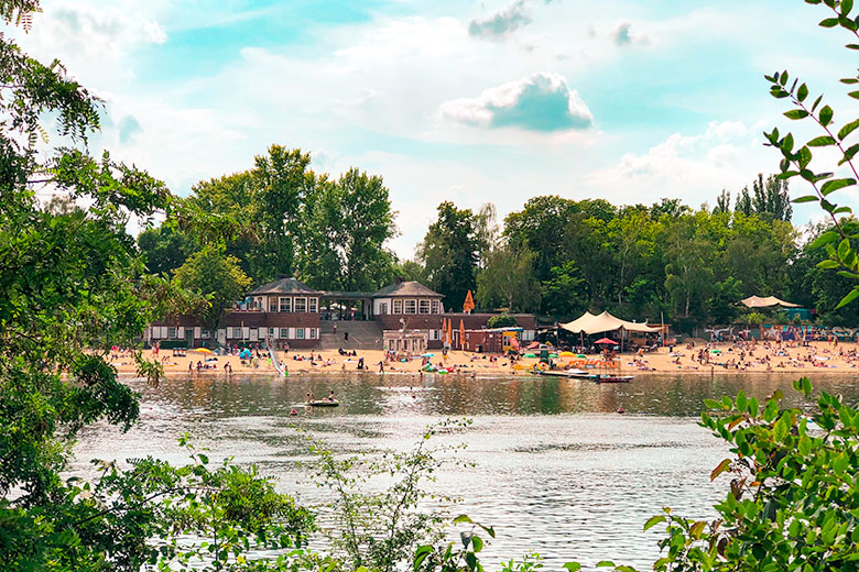 strandbad plotzensee lake in berlin germany with its sandy beaches - a popular outdoor thing to do and has lifeguards, volleyball and stand up paddling