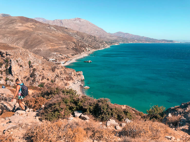 the hiking trail from the parking to preveli beach with an aerial view of the clear, turquoise blue waters of the libyan sea