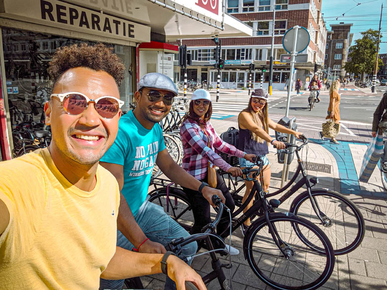 a group of friends renting a bicycle from a bike rental shop