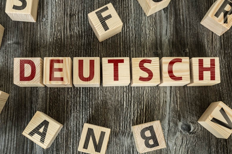 wooden game blocks spelling out the word deutsch which means german in english