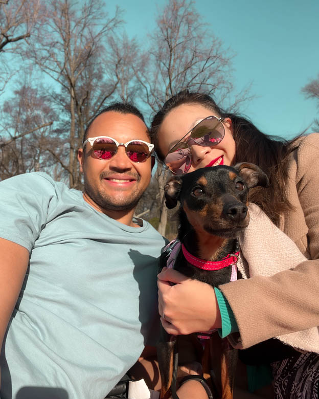 a couple in tiergarten berlin taking a selfie with their adopted dog