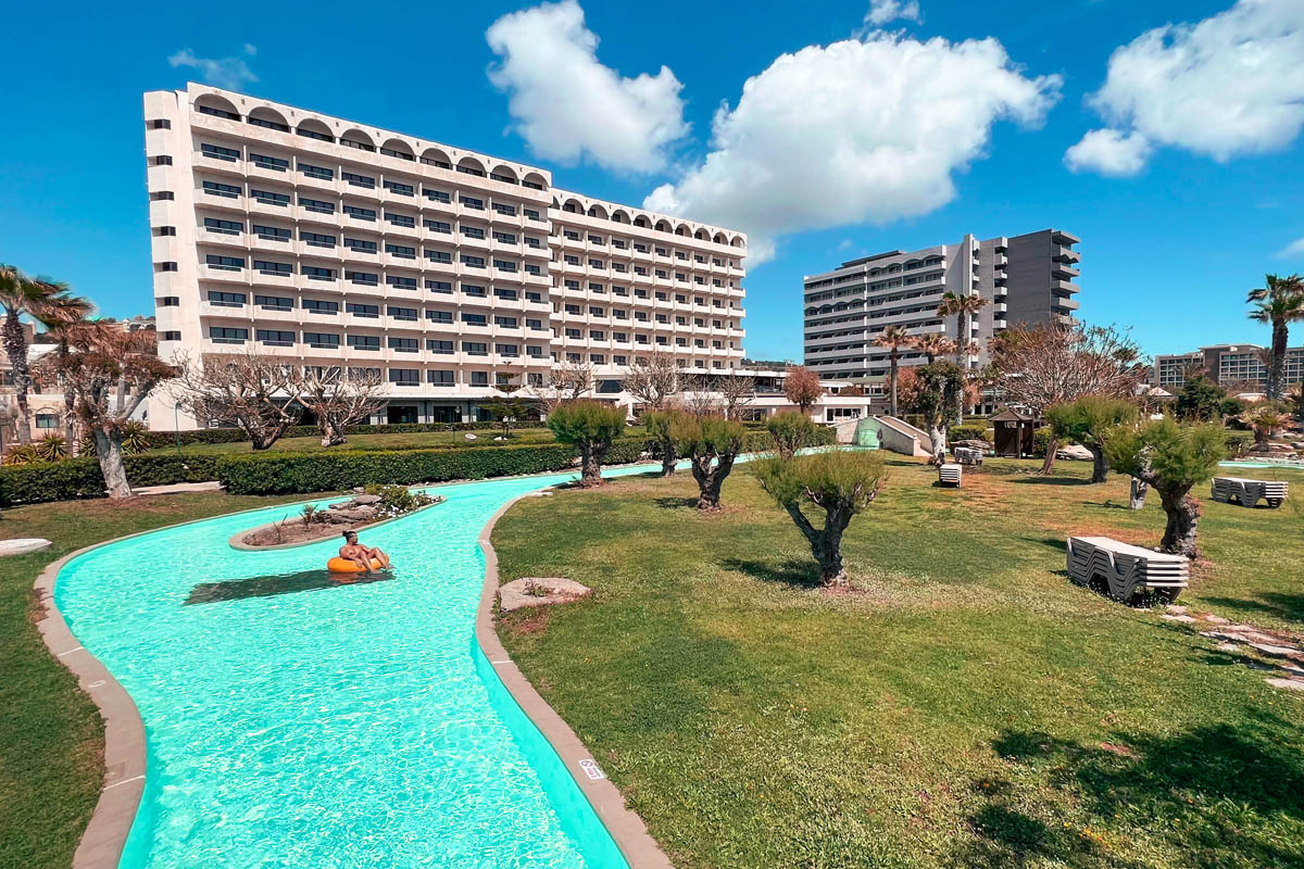 a man floating in the lazy river pool at esperos palace resort