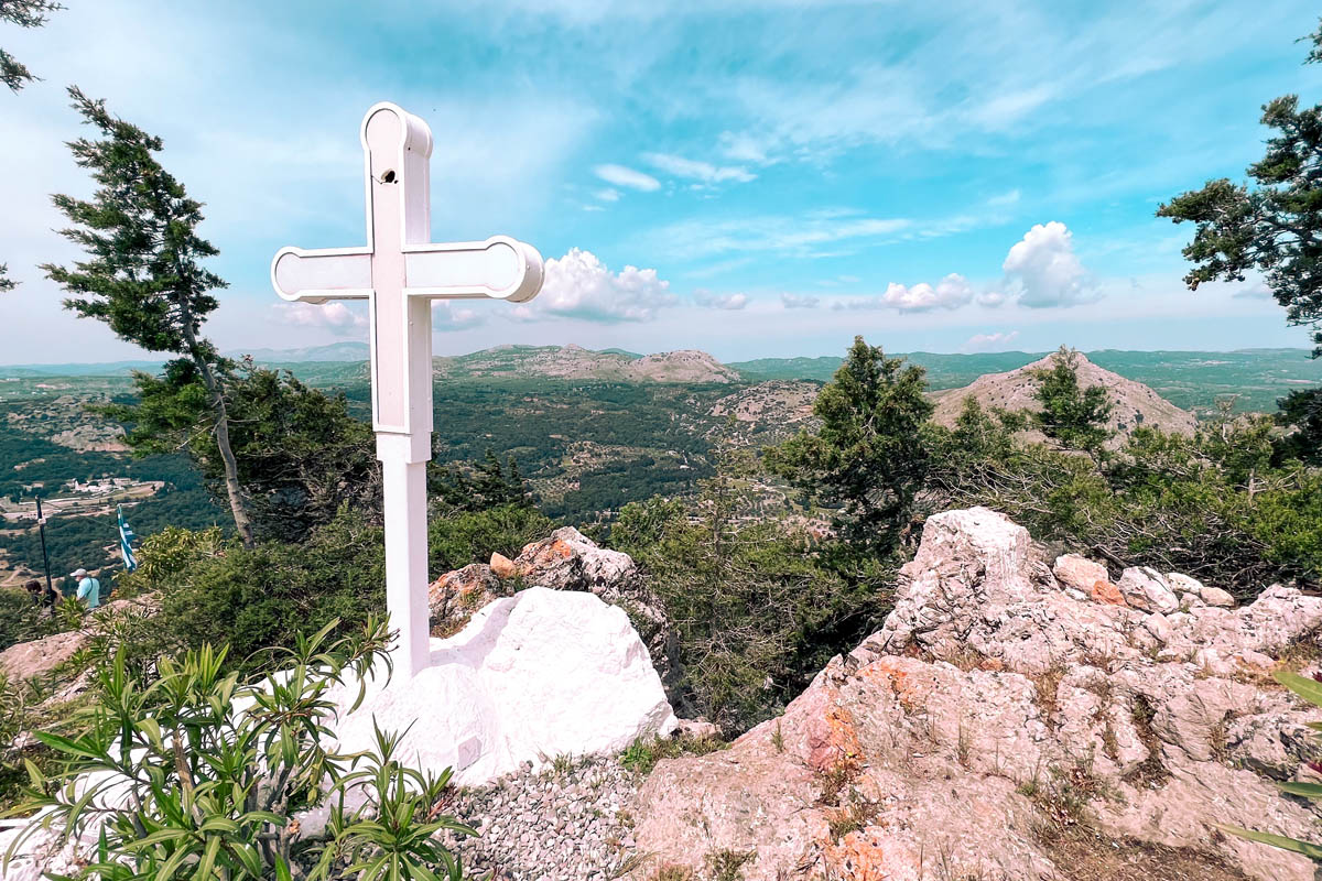 a white cross next to the holy monastery of virgin mary near tsambika beach