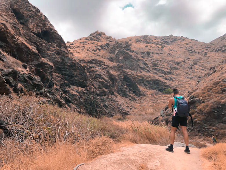 a man hiking a rocky, dry terrain on the greek island crete