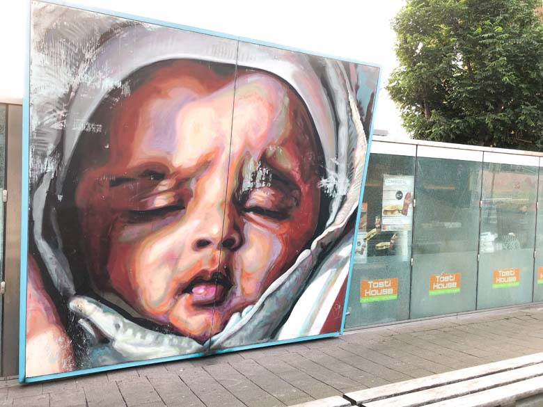 beautiful street art in rotterdam of baby sleeping