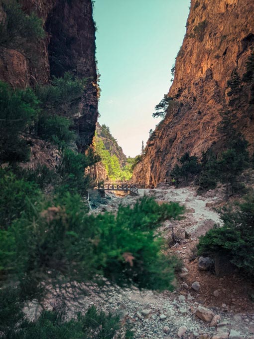 a view of the main hiking path in samaria gorge national park with a view of a bridge 