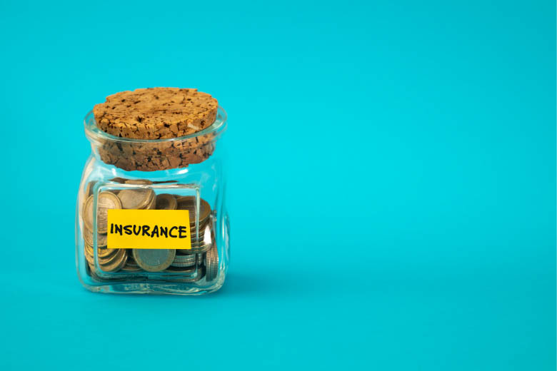 a glass jar with the word insurance on it explains ways to save money and reduce costs getting insurance in germany
