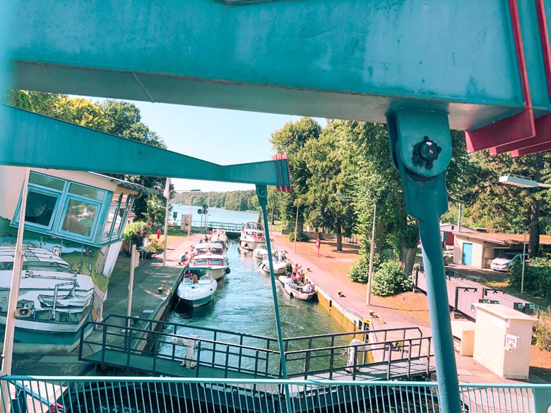 Schleuse Woltersdorf or the floodgate system with yachts and boats waiting on the waters before entering Flakensee lake