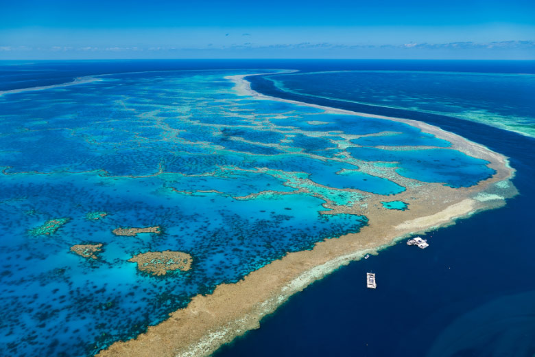 liveaboard diving boats anchored on the edge of the Great Barrier Reef in Australia