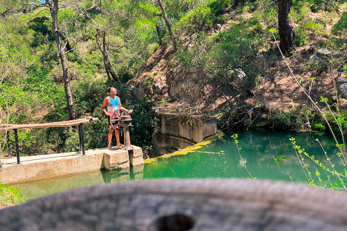 a man standing near the seven springs lake in rhodes greece