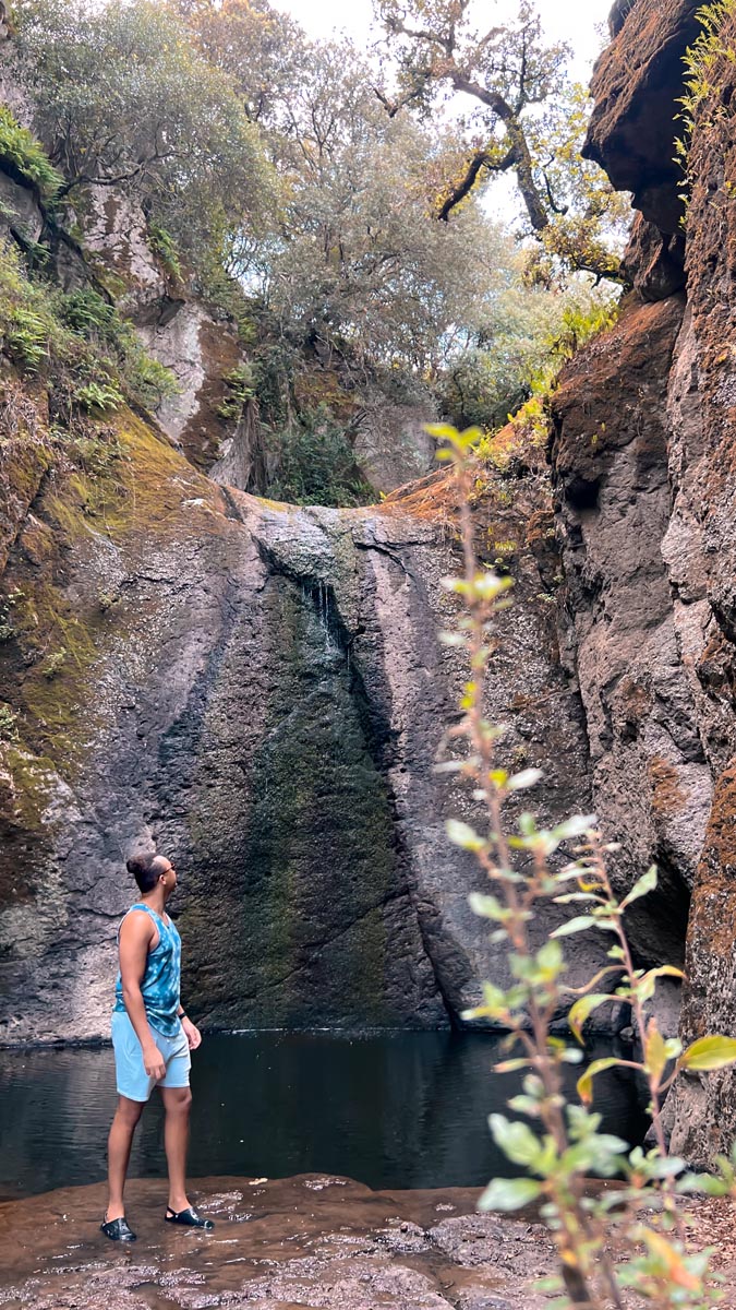 a man standing in front of a waterfall in north central sardinia