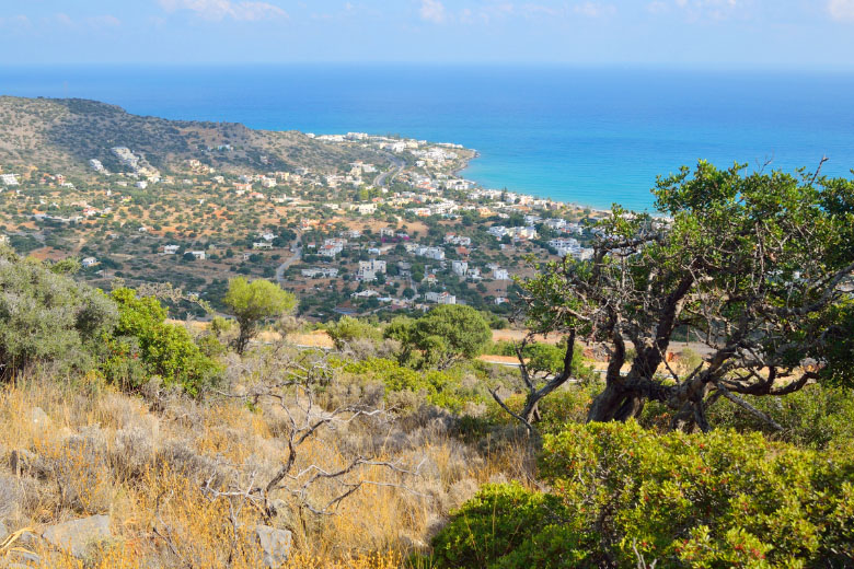 view of stalis or stalida town in crete from the mountains in greece