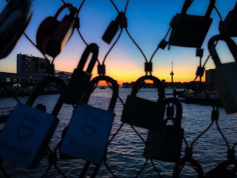 best sunset in rotterdam with view of locks on bridge and euromast tower