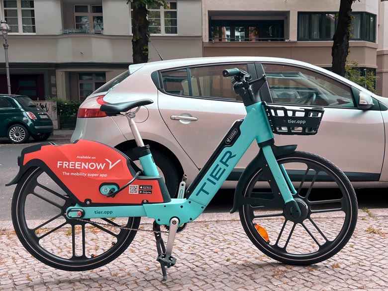 turquoise color tier e-bike parked on the pavement in berlin