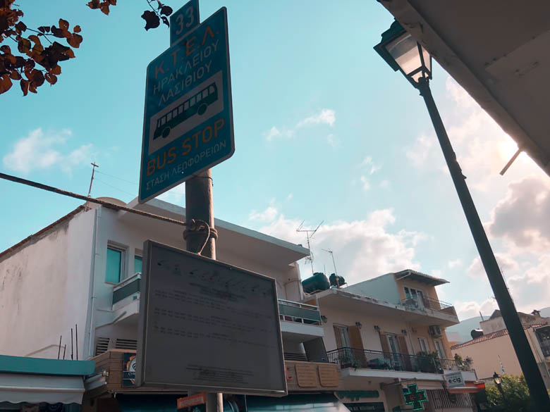 a bus stop in crete with a schedule of when public transport arrival and departure times