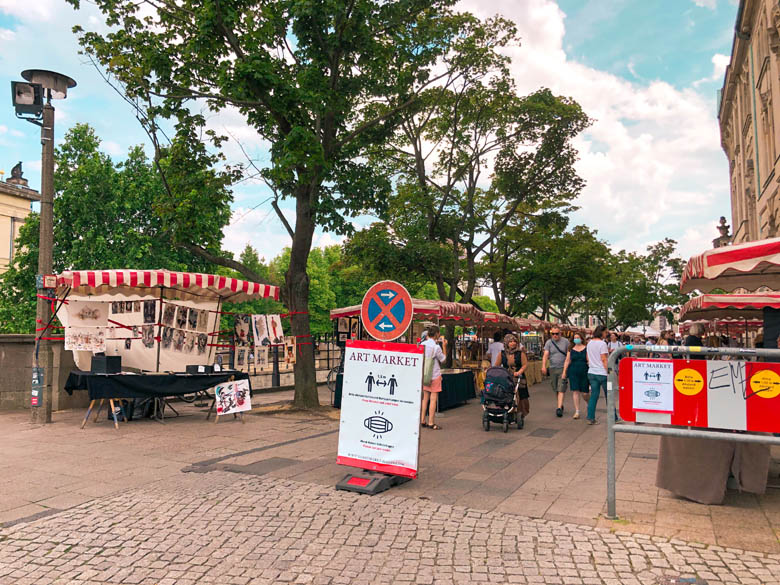 a flea market in berlin during covid with guests wearing masks