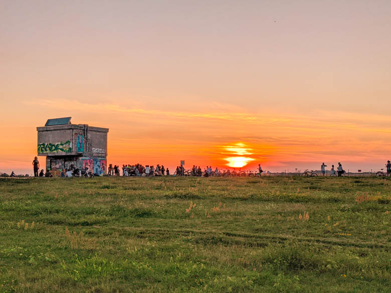 people gathering at tempelhof feld in berlin during sunset during coronavirus or covid pandemic