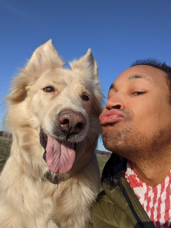 a man taking a selfie with a dog in berlin tempelhof park