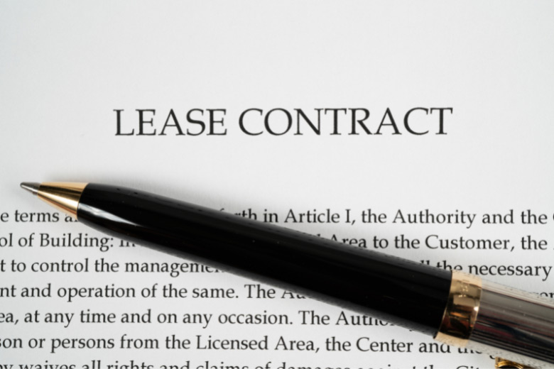 a pen placed across a paragraph of a lease contract