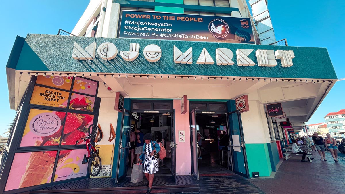 a local walking out of mojo market in sea point cape town