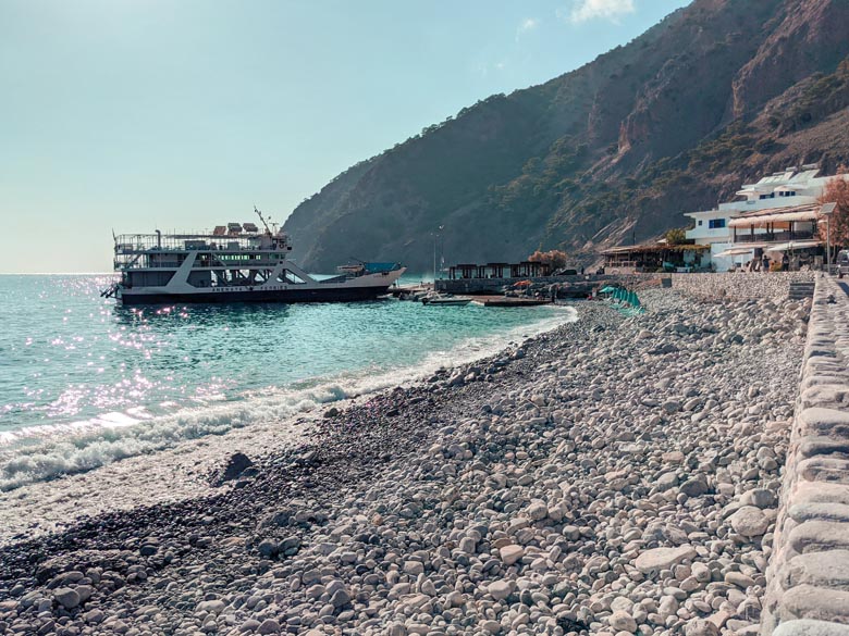 a boat floating on the sea near agia roumeli beach