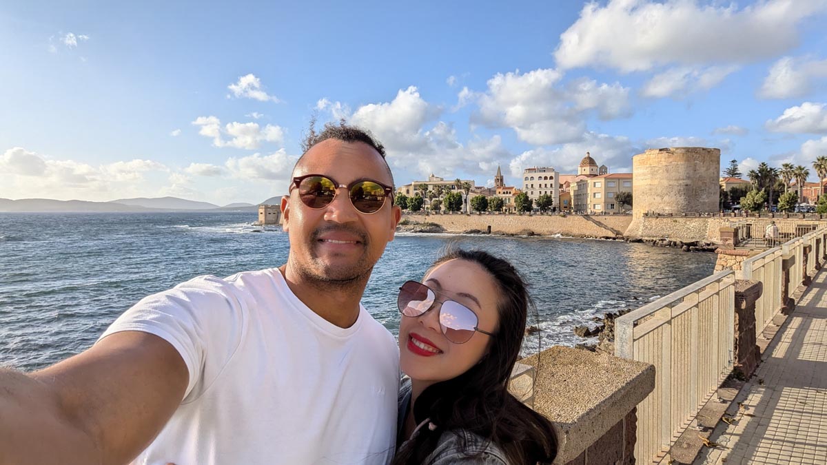 a couple taking a selfie along the promenade in alghero north west sardinia
