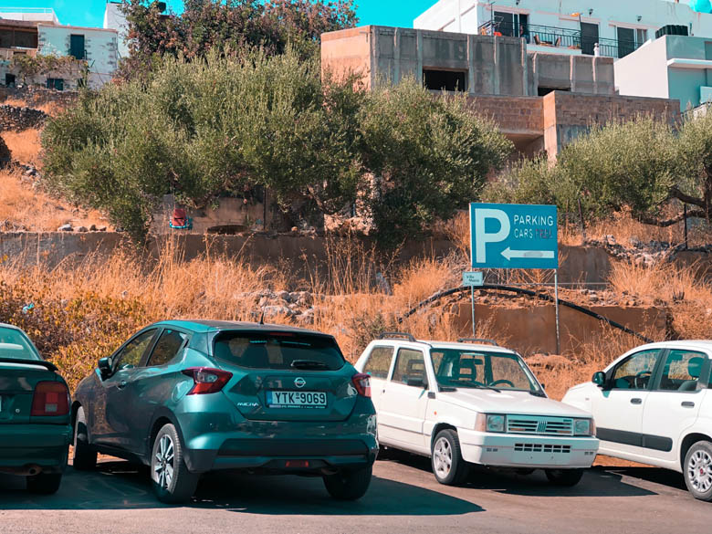 outdoor on the street parking on crete island with houses in the background