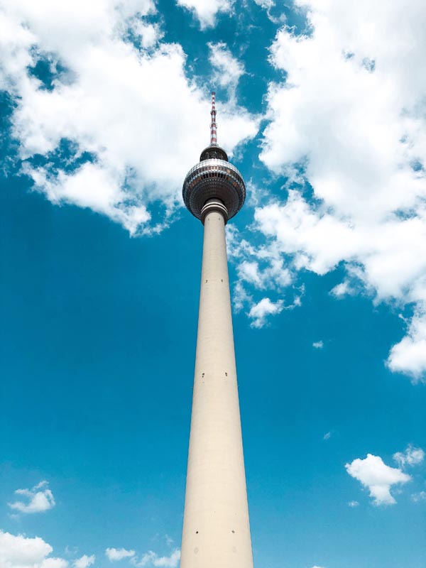 berlin tv tower on a day with blue skies and scattered clouds